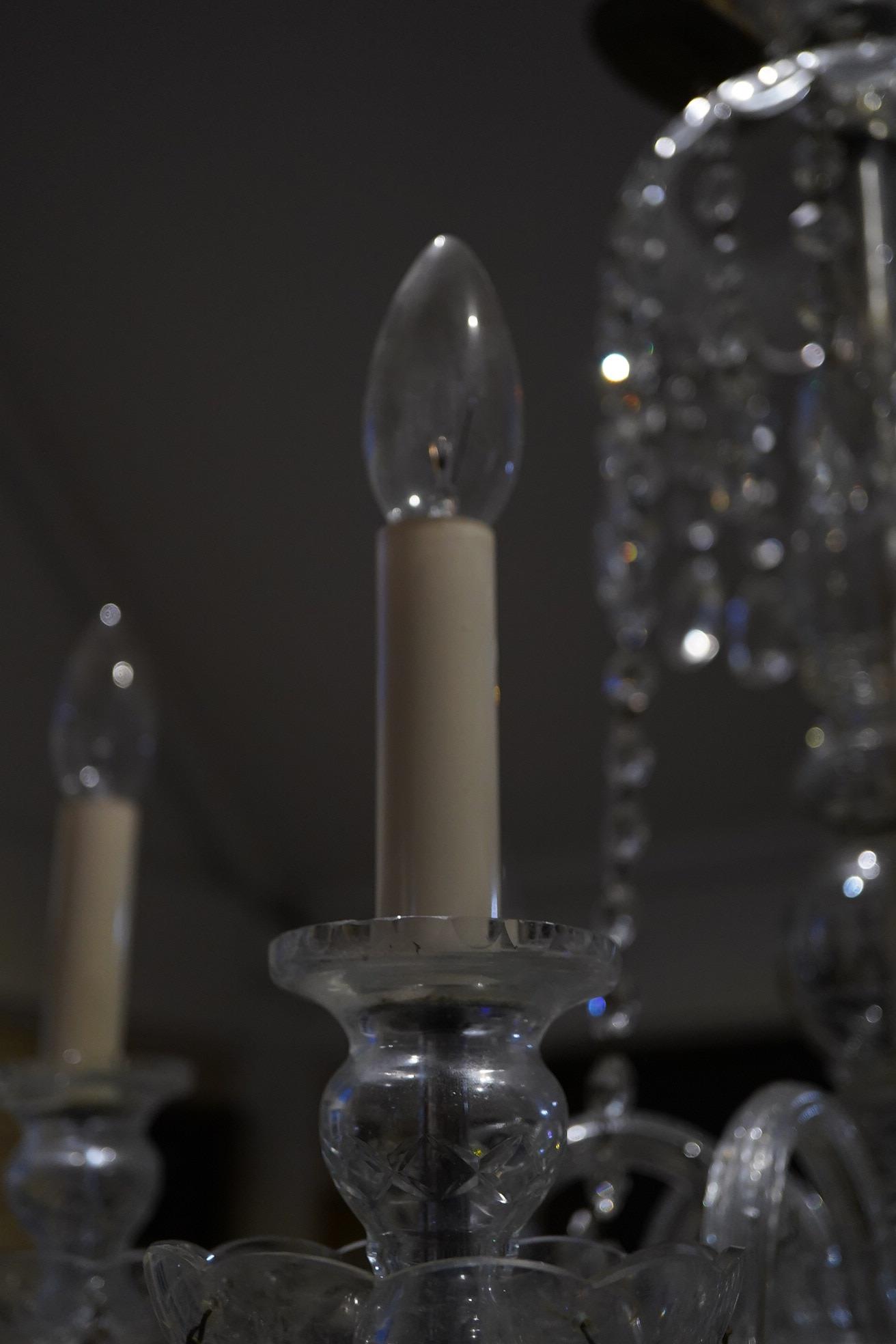A cut glass five branch chandelier with drops